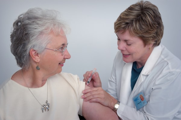 Caregiver assisting elderly patient